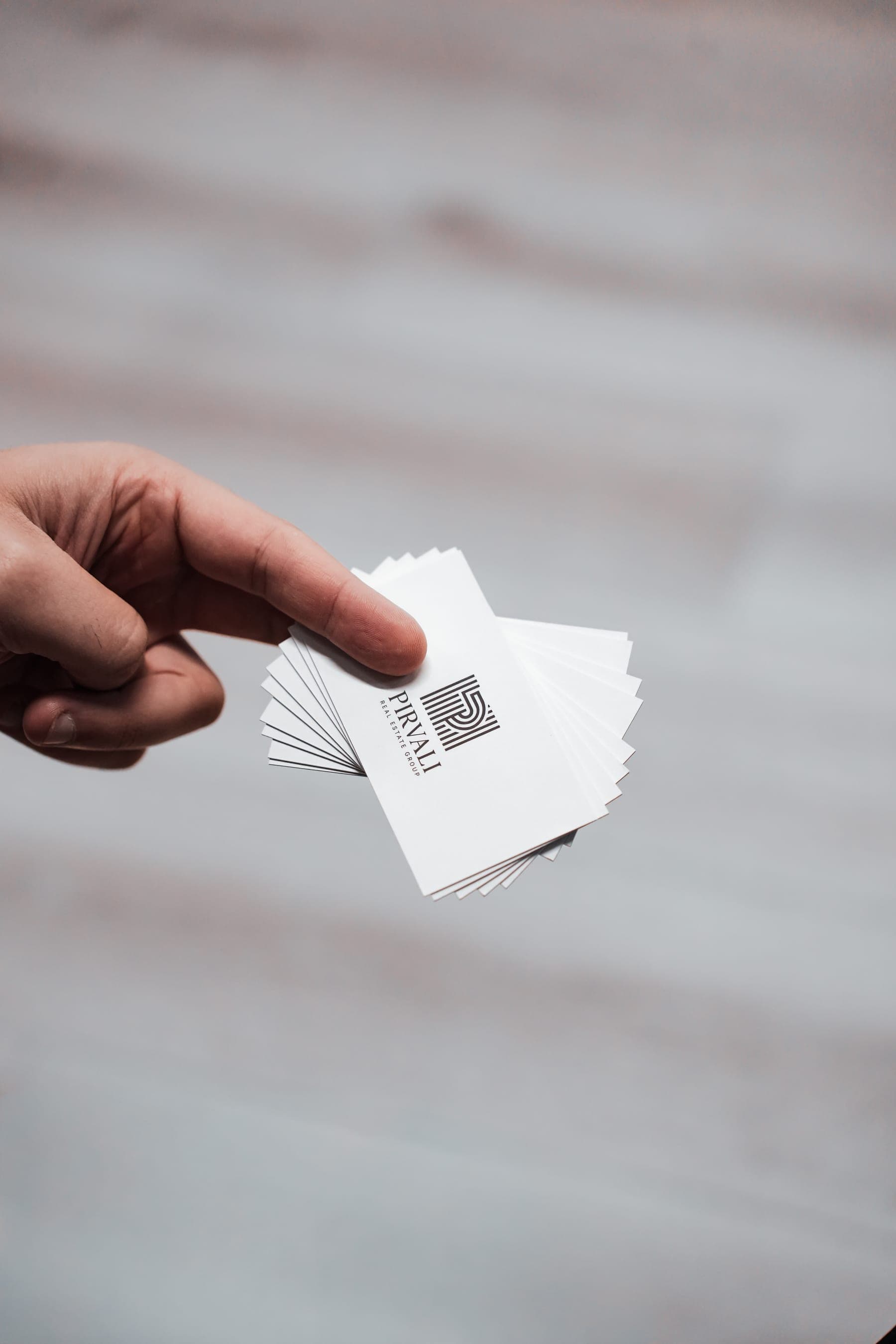 A fanned stack of Pirvali Real Estate Group business cards