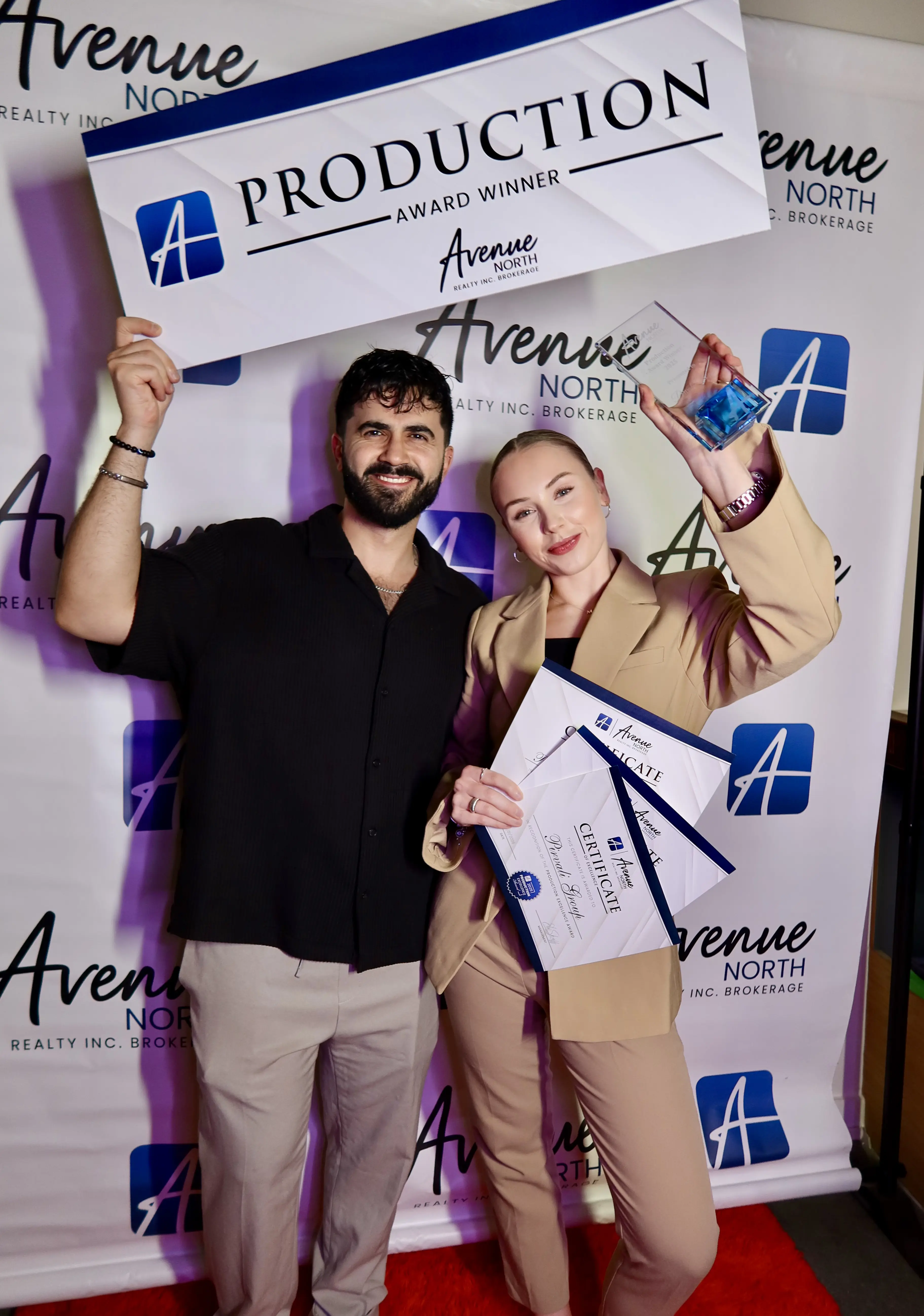 Ash and Mila Pirvali accepting Avenue North Realty 2025 Production Excellence Award
