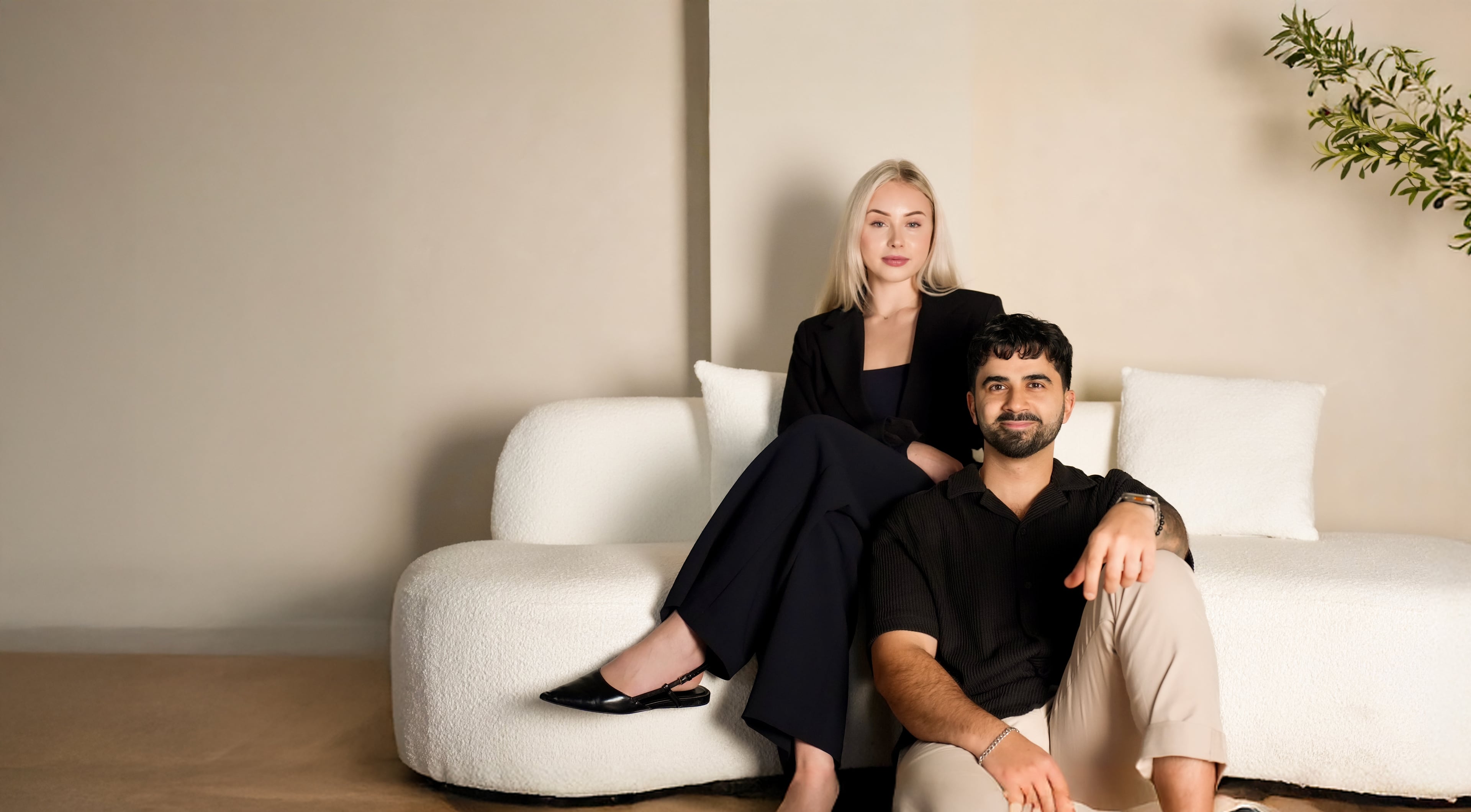 Ash and Mila Pirvali sitting on a sofa